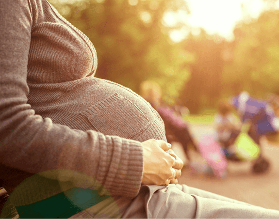 pregnant woman sitting outside